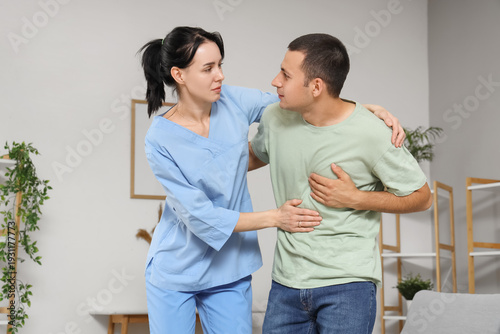 Female doctor helping man w...