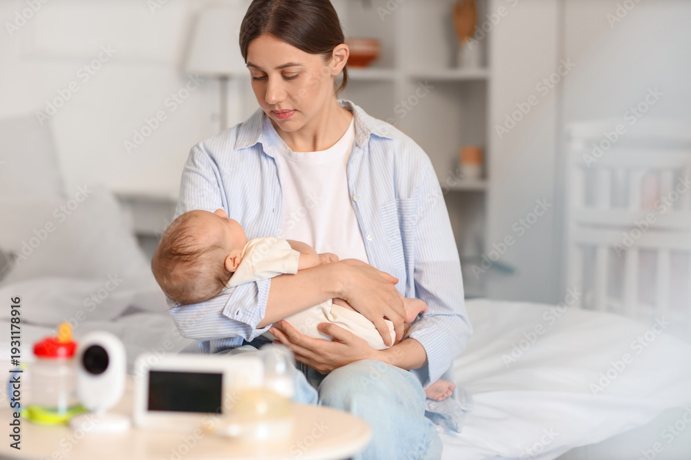Fototapeta premium Mother with her little baby sitting in bedroom