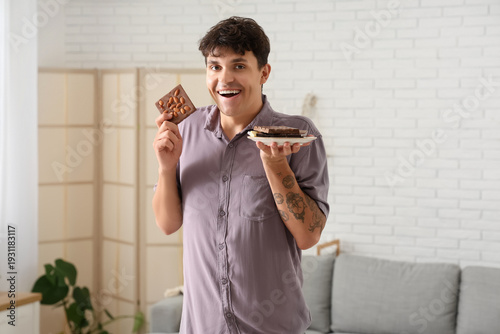 Happy young man holding pla...