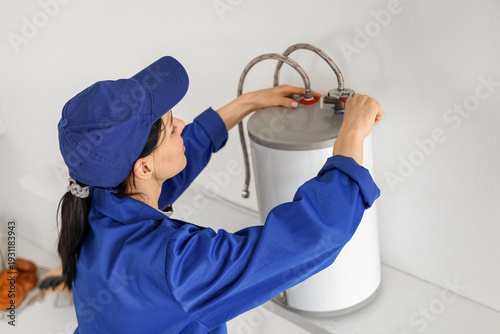 Female worker with wrench i...