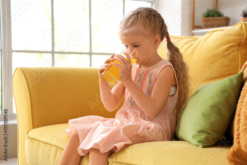 Cute little girl drinking o...