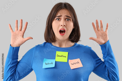 Young stressed woman holdin...