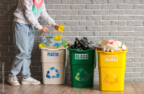 Woman putting garbage into ...