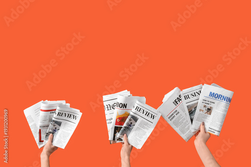 Women with newspapers on or...