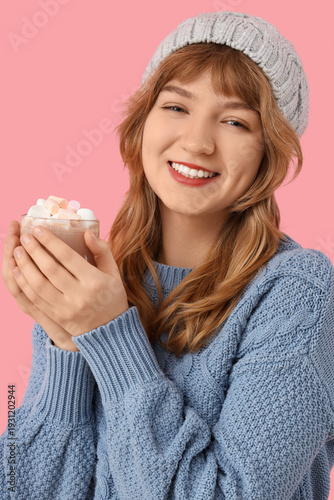 Pretty young woman holding ...