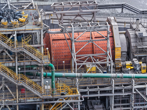 View of a huge ball mill operating in a mineral processing plant
