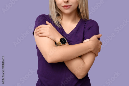 Young woman hugging herself...