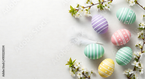 Minimalist Pastel Easter Eggs Flat Lay with Spring Flowers on White Background, Overhead View for Greeting Card, Invitation, or Social Media Design with Copy Space
