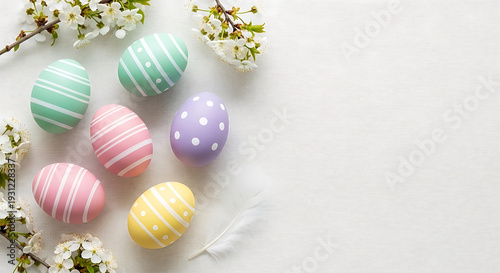 Minimalist Pastel Easter Eggs Flat Lay with Spring Flowers on White Background, Overhead View for Greeting Card, Invitation, or Social Media Design with Copy Space
