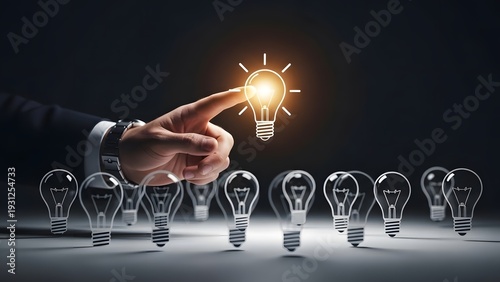 Finding the right business idea and leadership. Innovation and creative selection. Businessman hand pointing at one glowing lightbulb among several dark glass bulb icons.