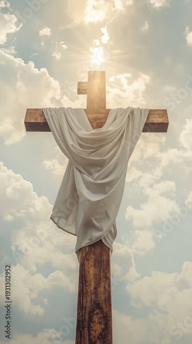 The symbol of christian faith and spirituality represented by a cross against a cloudy sky with sunlight