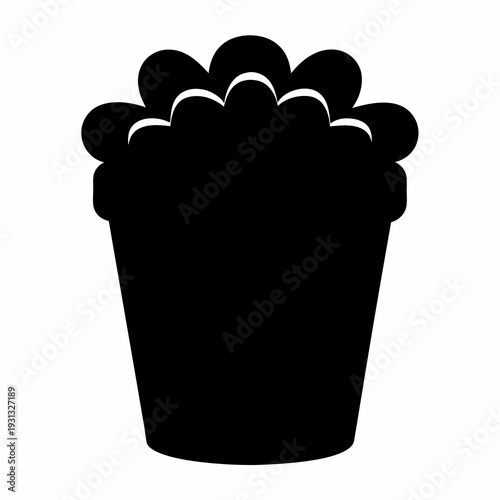 Silhouette of a container filled with a fluffy substance, possibly popcorn or cotton candy