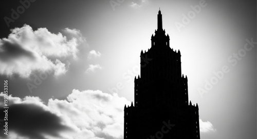 Silhouette of a tall gothic skyscraper against a dramatic sky.