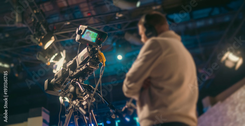 Φωτογραφία Professional TV camera in studio filming broadcast with cameraman on background