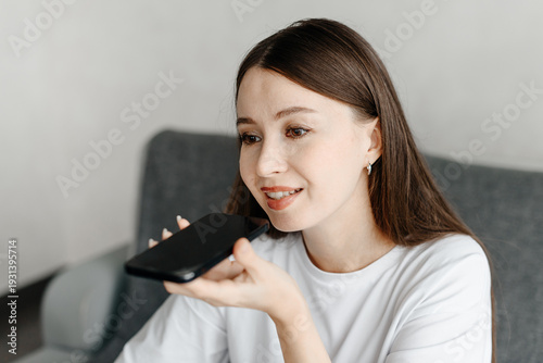 Photography young beautiful caucasian brunette woman recording voice message, smiling widely