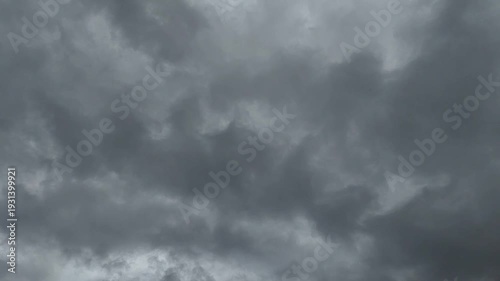 Fast-moving dark rain clouds filling the sky, creating a gloomy and intense atmosphere for creative projects.