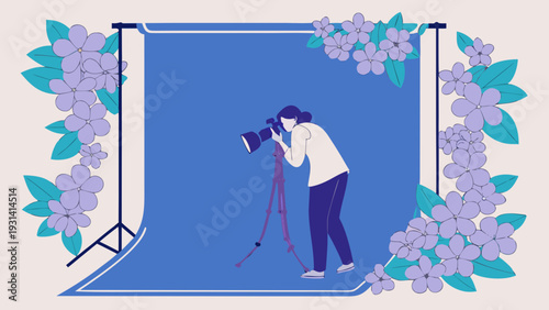 Photographer capturing images in a studio with floral frame.