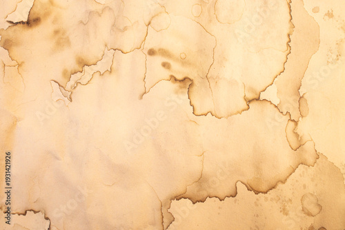 Water damaged beige paper with brown marks and stains, abstract backdrop or overlay template with copy space
