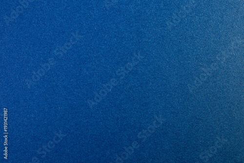 Dark blue recycled paper cardboard fiber structure, abstract empty backdrop, detailed close up
