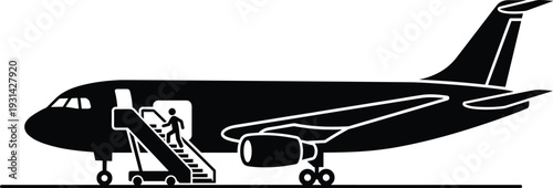 Black airplane with boarding stairs attached to its door white