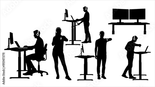 Silhouetted professionals working on computers in a modern office environment viewed from above