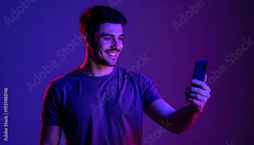 Young Man Taking a Selfie with Smartphone in Neon Lighting.