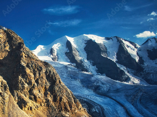 Majestic snowy mountain peaks and glaciers under a clear blue sky