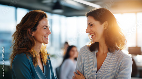 Wallpaper Mural Two faceless professionals engaging in friendly conversation in modern office with large windows natural light flooding space contemporary workplace business discussion Torontodigital.ca