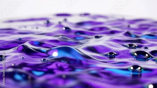 Purple Liquid Droplets Ripples Closeup View.