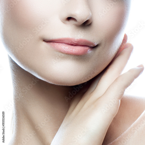 Close up lips and hands of beautiful young woman isolated on white background. Smile and happy