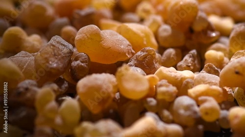 Frankincense olibanum resin, Boswellia sacra background. Frankincense or olibanum natural aromatic resin used in incense and perfumes, rotating backdrop, design, macro shot, top view, close up  