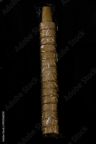 Ice cream cone row in plastic Isolated on black background
