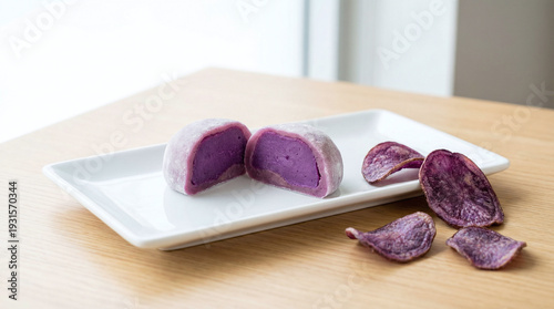 Purple Sweet Potato Mochi with Crispy Chips on a White Plate Against a Light Wooden Background