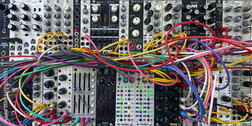 modular sound synthesizer eurorack system with colorful patch cables widescreen banner