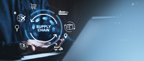 Supply chain management digital concept with logistics icons and circular interface held by hands over laptop in creative futuristic blue background.
