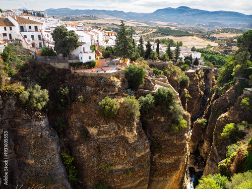 Whitewashed houses and apartments cluster the edge of the gorge at Ronda, Spain