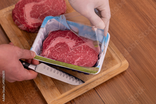 The beef is being unpacked from the package.