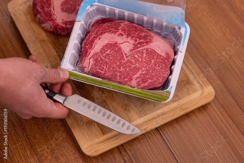 The beef is being unpacked from the package.