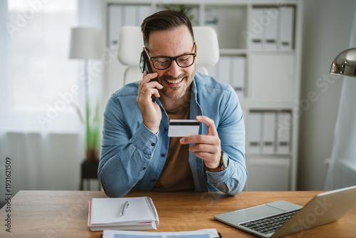 Bild auf Leinwand Man shopping online using credit card and phone