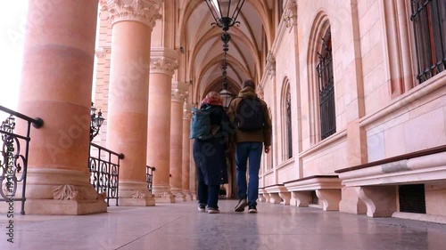 Middle aged couple holding hands and walking into distance away from camera