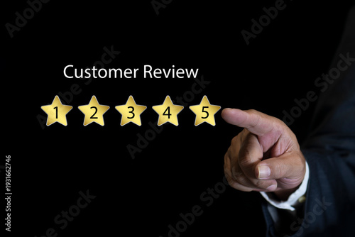 Customer review satisfaction feedback survey concept. Businessman using smartphone to give five-star positive review. Online ratings and excellent service.