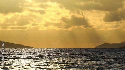 Magnificent sunset on a cloudy day over the Aegean Sea in autumn.	
