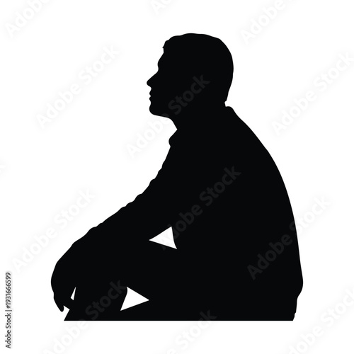 Silhouette of a man sitting in a thoughtful posture