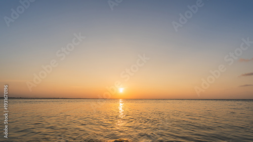 Sunset sky clouds over sea in the evening with Orange sunlight Golden hour, Landscape horizon sea sky, Dusk sky nature background