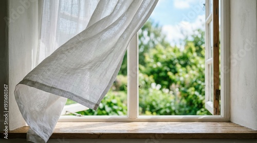 white curtain blowing in the wind by open window