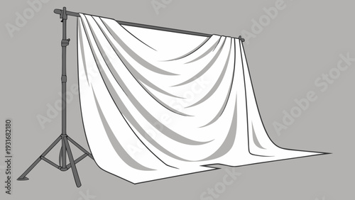 White backdrop on stand for photography studio setup.