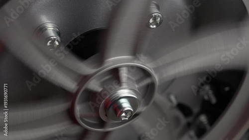 Metal wheel mechanism on a shaft of an industrial machine, rotation, close up