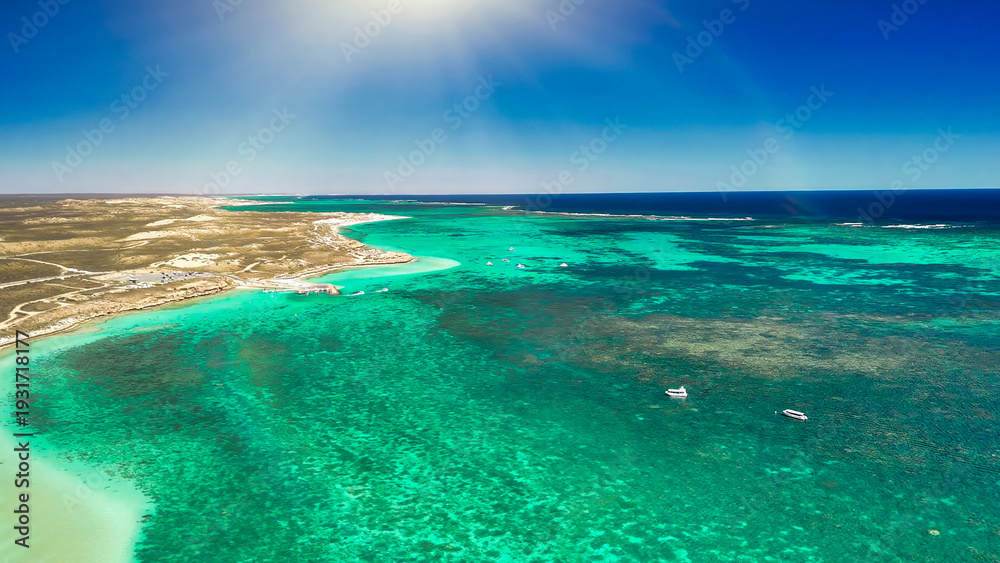 Obraz premium Aerial view of Coral Bay and beach in Western Australia with turquoise ocean and white sand