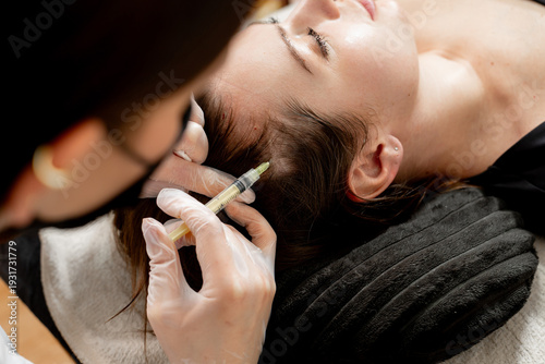 A lady receiving hair mesotherapy injections from a professional trichologist. Hair treatment in cosmetology with the help of injections for hair growth