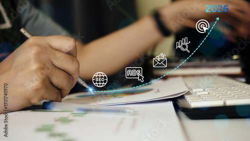 Businesswoman analyzing marketing growth chart with SEO and online advertising icons, digital strategy planning for 2026, performance analytics, target optimization  business revenue growth concept.